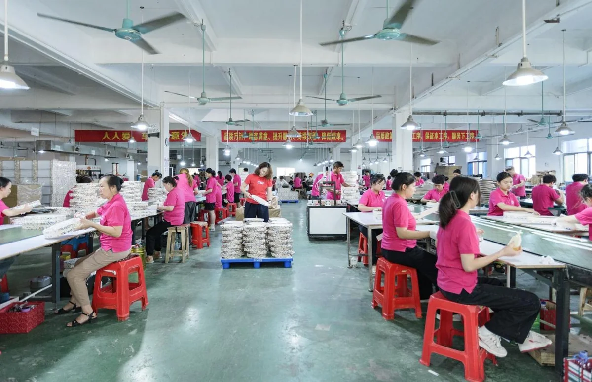 Production team working across a bright party-supply factory floor