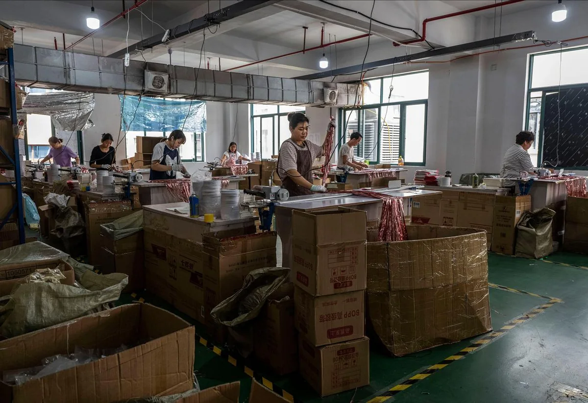 Party products being prepared beside packed cartons in a production workshop