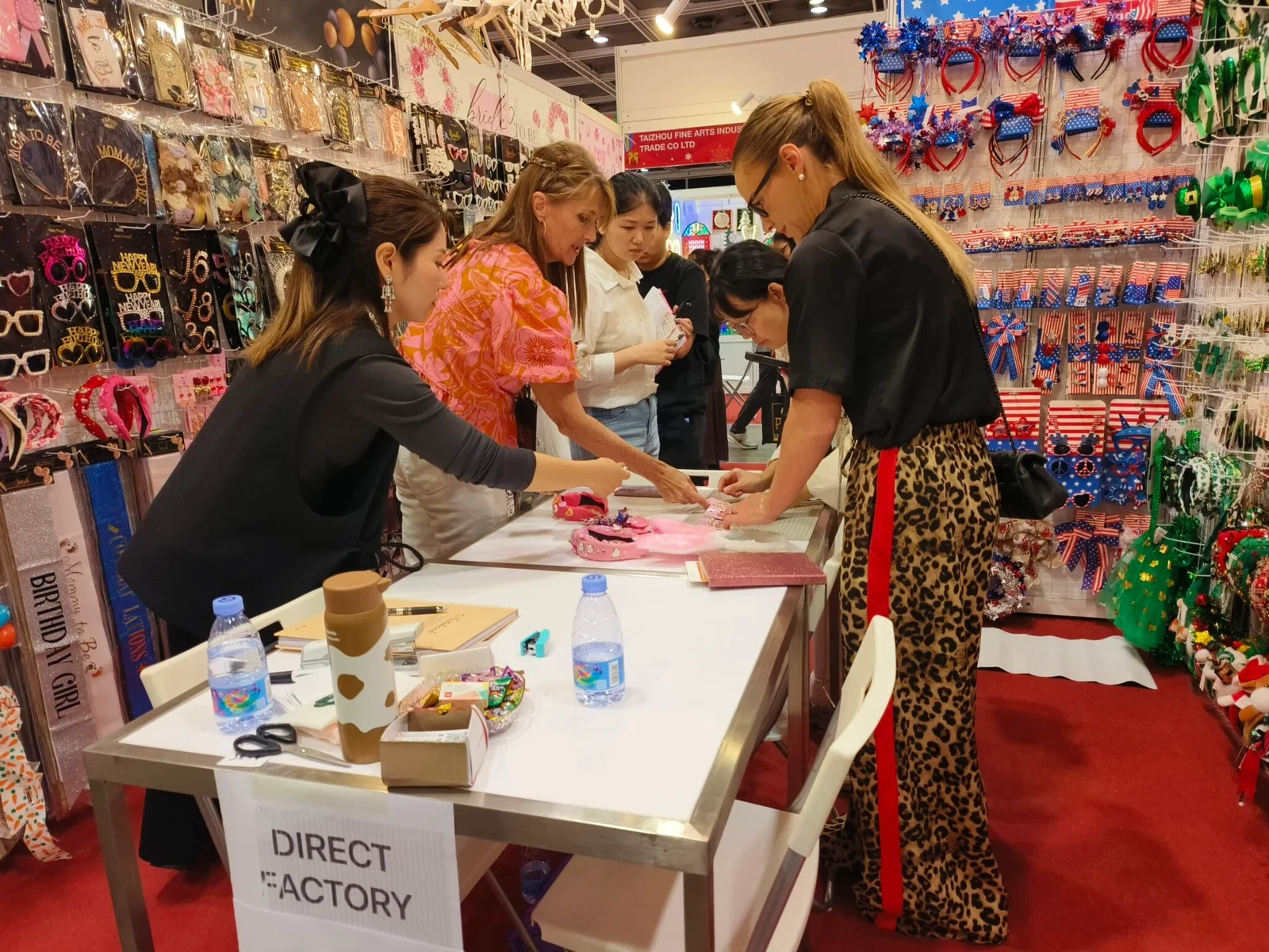 Buyers discussing party product samples with the exhibition team