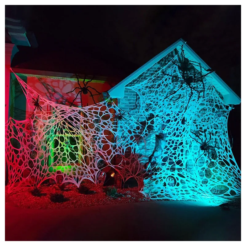 Colorful stretch spider web decorations covering the exterior of a house