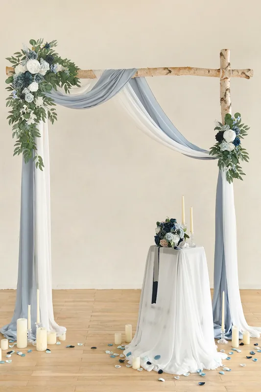 Blue drapery and white floral accents arranged on a rustic wedding arch