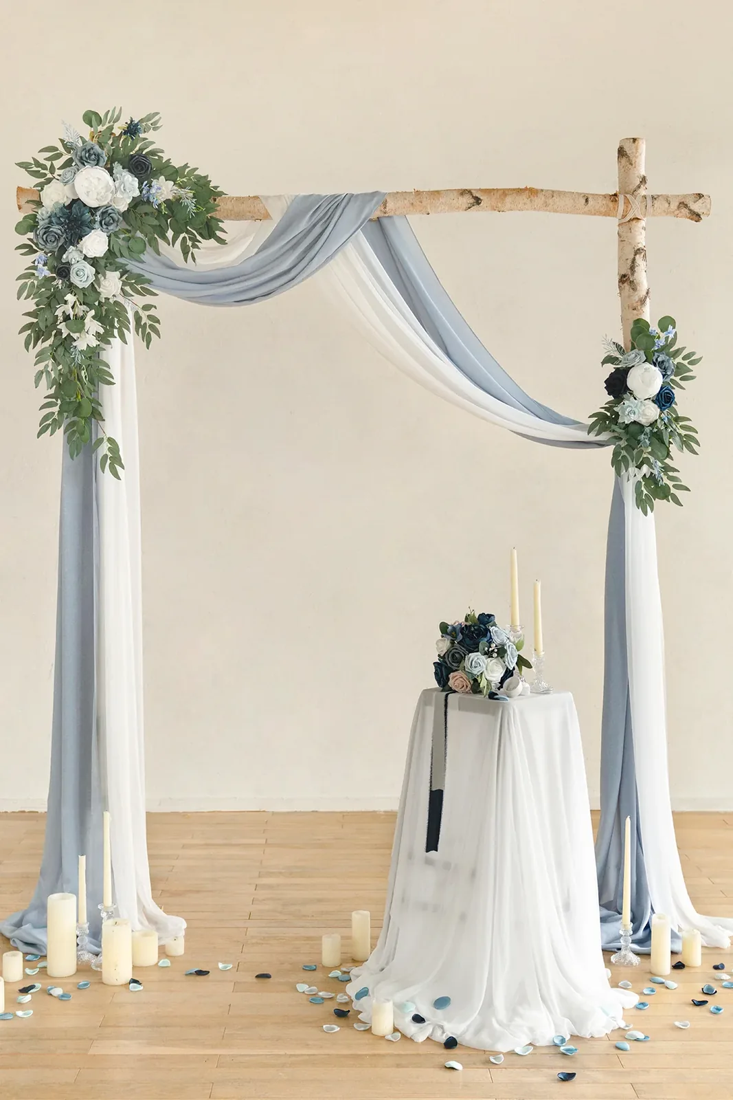 Blue drapery and white floral accents arranged on a rustic wedding arch