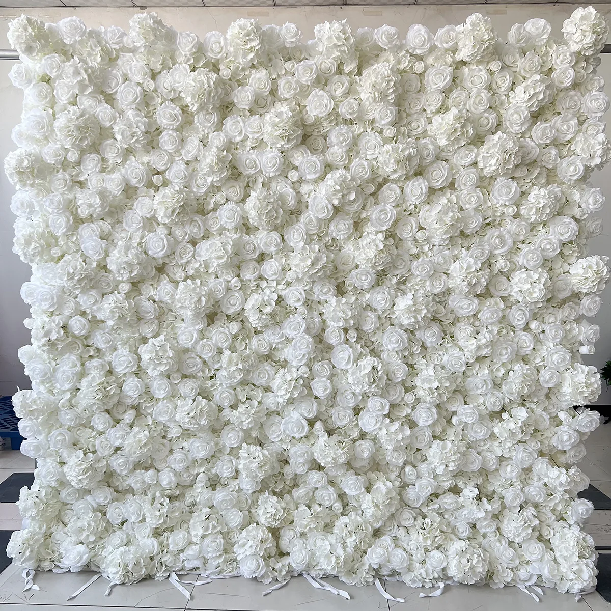 White flower wall backdrop photographed outdoors